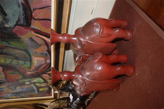 A Chinese carved wood horse group and a pair of lacquered elephant candlesticks